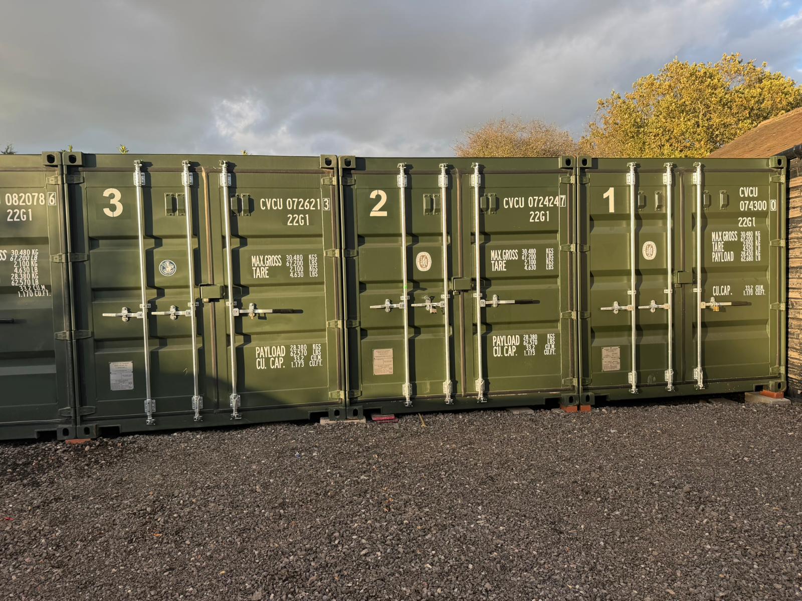 Row of numbered shipping containers on site